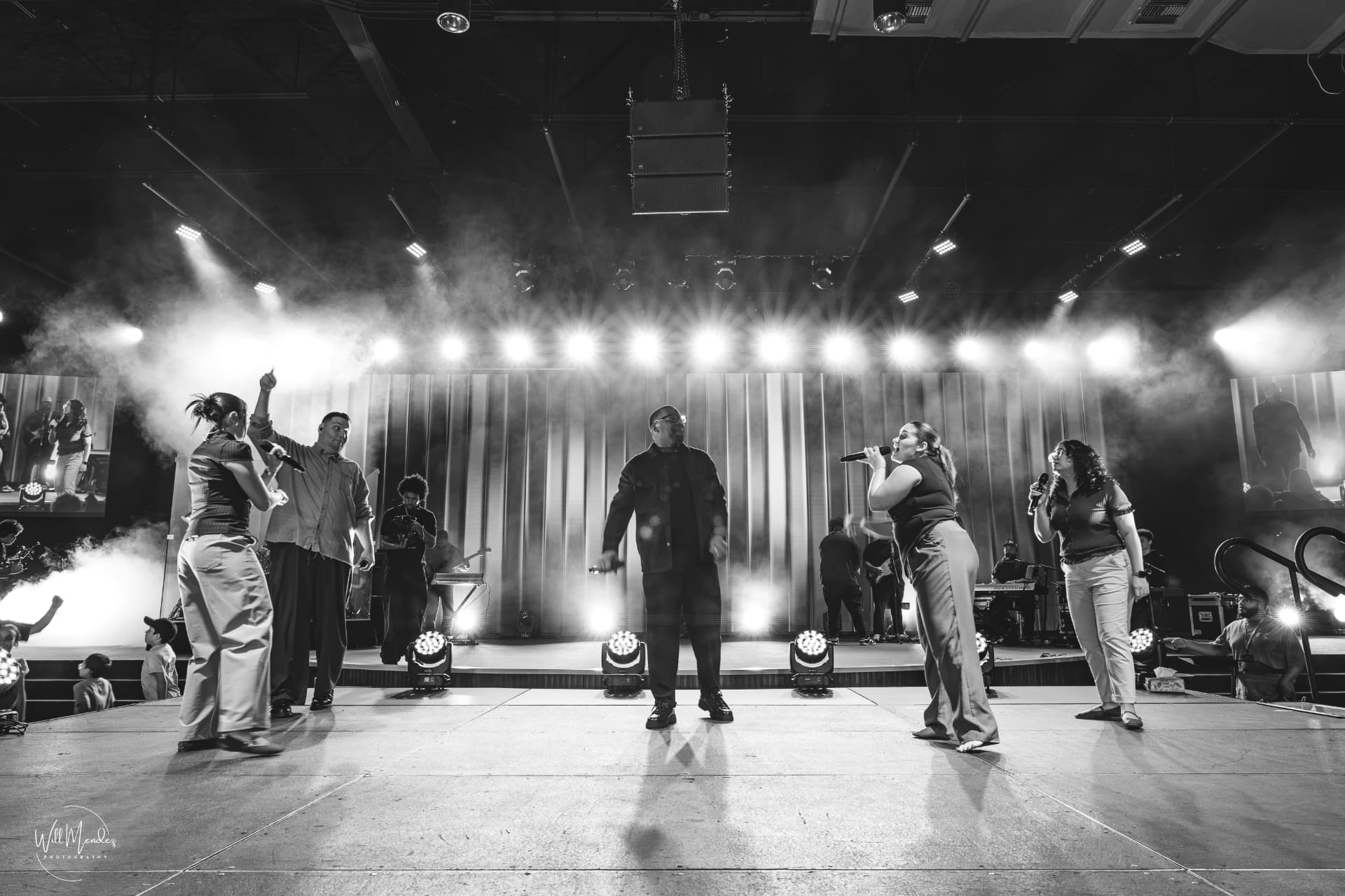 EJ LaTouche and the worship team under stage lights
