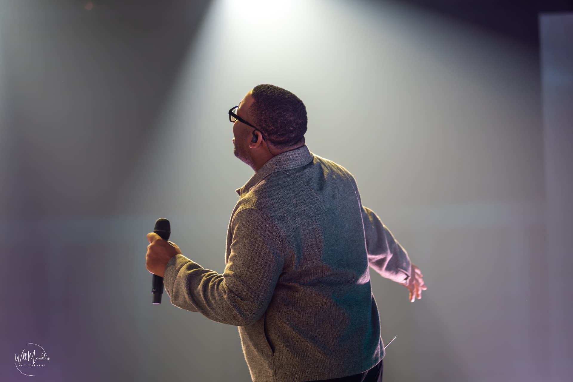 EJ LaTouche onstage under a spotlight