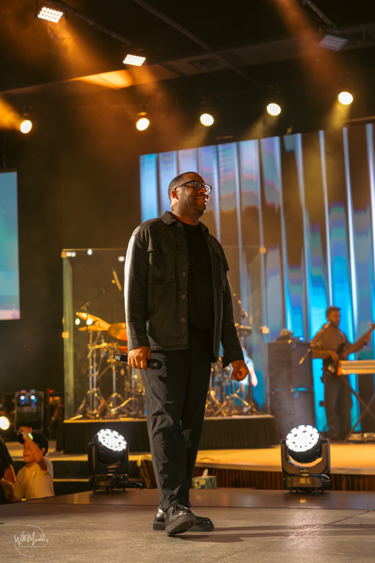 EJ LaTouche walking onstage under warm light